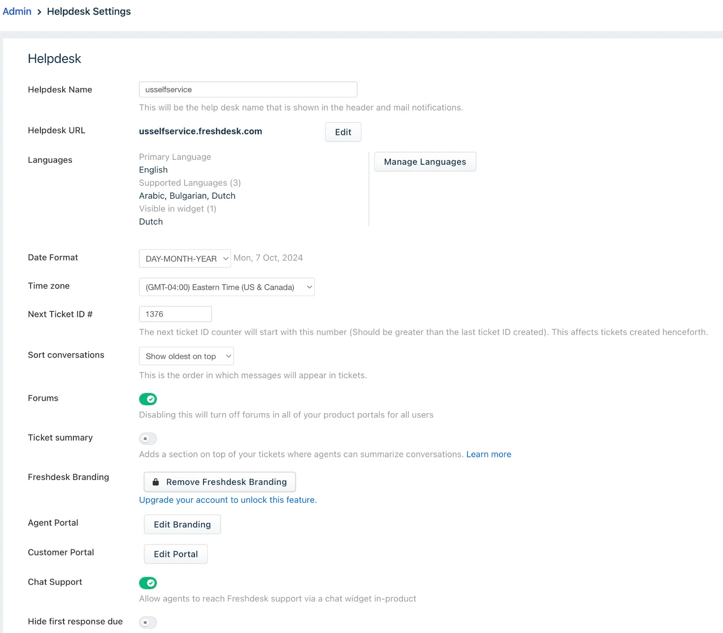 Freshdesk admin settings, where the branding-removal option sits behind an "Upgrade your account to unlock this feature" link, as taken from the Freshworks help centre